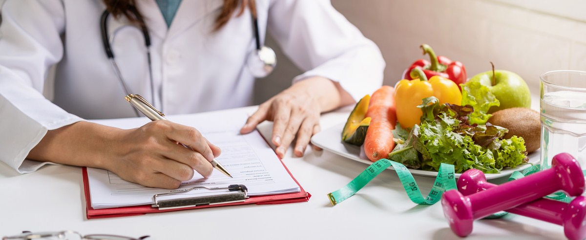 Nutritionist giving consultation to patient with healthy fruit and vegetable, Right nutrition and diet concept