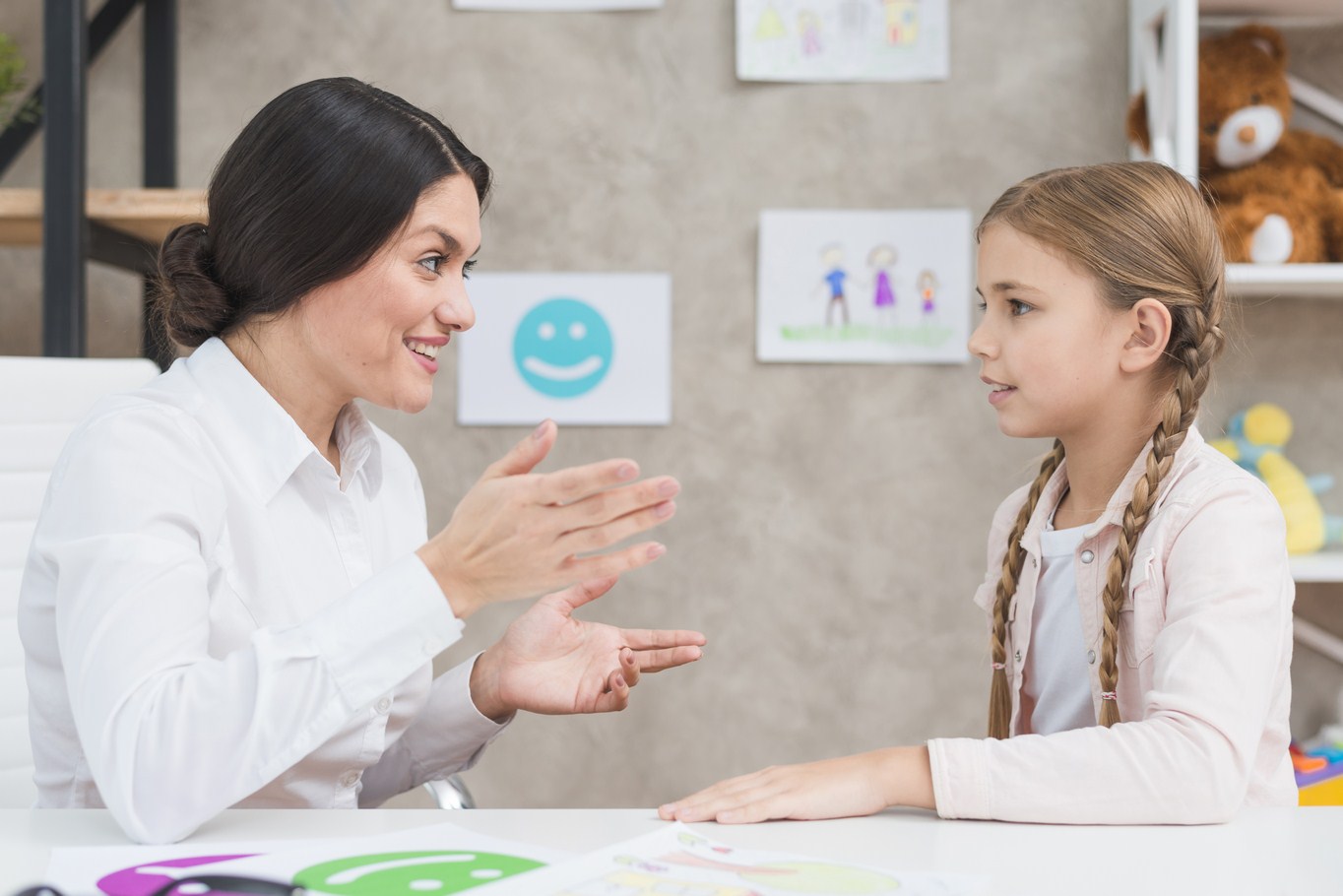 smiling-portrait-girl-female-psychologist-having-conversation-office